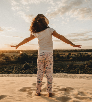 one little girl stand on the sand photo